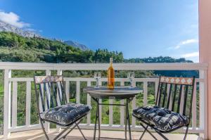 a table and two chairs on a balcony with a view at Apartments Seaview in Tučepi