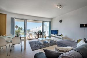 a living room with a couch and a table at Apartamento Vista Mar - Arte Nova Fuseta in Fuzeta