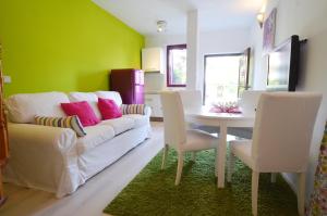 a living room with a white couch and a table at Apartments Villa Rossella 3 in Rovinj