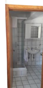 a bathroom with a shower and a sink and a tub at Apartments Andrijana in Drače