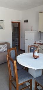 a living room with a white table and chairs at Apartments Andrijana in Drače