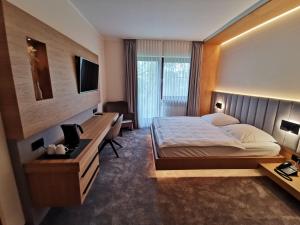 ein Hotelzimmer mit Bett und Schreibtisch in der Unterkunft Landhaus Beckmann in Kalkar