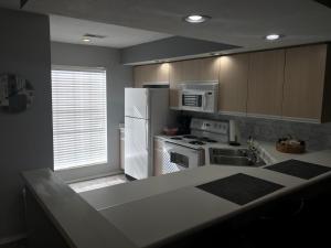 a kitchen with a white refrigerator and a stove at Lakeside Condo on Lake Taneycomo in Branson