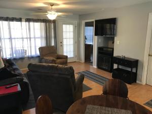 a living room with a couch and a table at Lakeside Condo on Lake Taneycomo in Branson