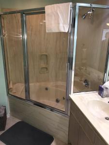 a shower with a glass door in a bathroom at Lakeside Condo on Lake Taneycomo in Branson