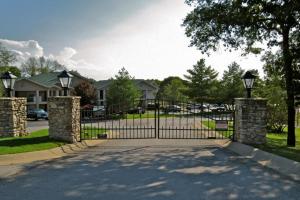 a driveway with a gate in front of a house at Quiet and Serene Condo in Branson in Branson