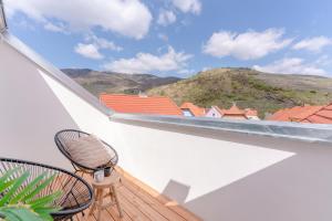 a balcony with a chair and a view of a mountain at Dach.Loft Spitz in der Wachau in Spitz