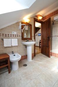 a bathroom with a sink and a toilet at Hotel Rural El Espino in Cangas de Onís