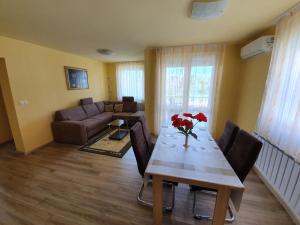 a living room with a table and a couch at Bodó Park Apartment in Hévíz
