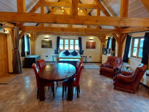 a dining room with a table and chairs and a bedroom at Greenvale Barn in Cheadle