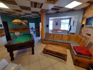 a living room with a pool table and a couch at Tiberias Hostel in Tiberias +61 photos