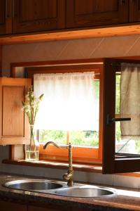 a kitchen sink and a window with a windowtaining at Quinta Amarela - B&B in Nazaré