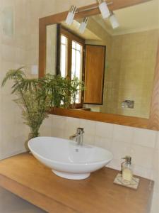 a white sink in a bathroom with a mirror at Rio d'Azenha - Country House in Roliça