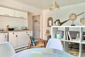 a kitchen and dining room with a table and chairs at #AL Le bleuet T2 with terrace in Échirolles