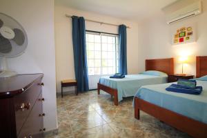 a hotel room with two beds and a window at Quinta Das Flores, Lote 9 in Albufeira +36 photos