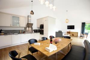 a kitchen and dining room with a wooden table and chairs at Ferienhaus Münzberg in Annweiler am Trifels
