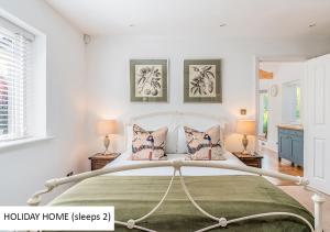 a bedroom with a large bed and two lamps at Cadnam Lodge in Cadnam