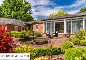 a home with a patio with a fountain in the yard at Cadnam Lodge in Cadnam