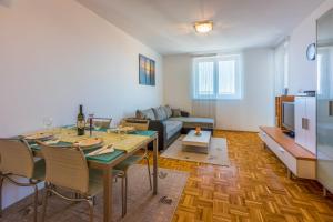 a living room with a table and a couch at Apartment Ruzica in Crikvenica