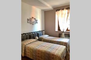 a bedroom with two beds and a window at Agriturismo Il Salicchio app.Benedetta in Pian dʼAlma