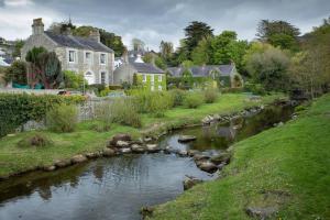 ein kleiner Fluss in einem Dorf mit Häusern in der Unterkunft Kilbroney River Cottage in Rostrevor