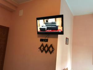 a flat screen tv on the wall of a living room at Hotel Colibri B&B in Rimini