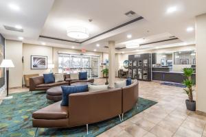 a lobby at a hospital with couches and tables at Candlewood Suites Portland Airport by IHG in Portland