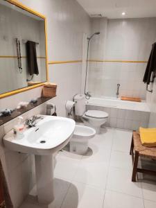 a bathroom with a sink and a toilet and a tub at Port Pollensa Pins Apartment sea view in Port de Pollensa +11 photos