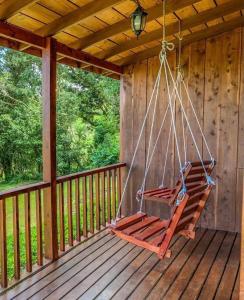 a swing on the porch of a cabin at Campo Verde B&B - Monteverde Costa Rica in Monteverde Costa Rica