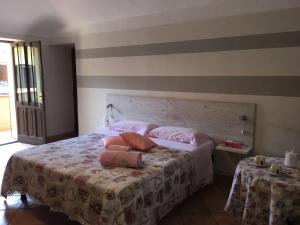 a bedroom with a bed with two pillows on it at B&B sotto le mura in Pavone Canavese