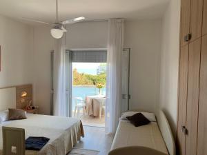 a bedroom with two beds and a view of a table at Hotel Sahara in Milano Marittima