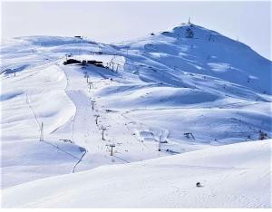 a snow covered mountain with a ski lift on it at 9598 SS301 Trepalle APPARTAMENTO MIKI in Livigno
