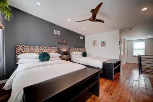 a bedroom with two beds and a ceiling fan at Artsy Hidden Gem - FREE PARKING in Philadelphia