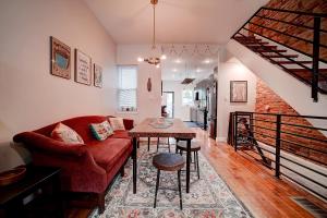 a living room with a red couch and a table at Artsy Hidden Gem - FREE PARKING in Philadelphia