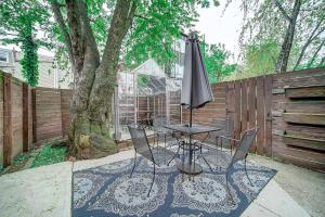 a table and chairs with an umbrella next to a tree at Artsy Hidden Gem - FREE PARKING in Philadelphia