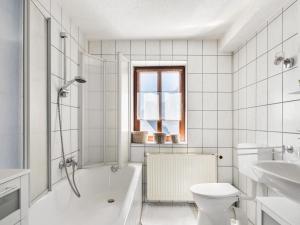 a bathroom with a tub and a toilet and a sink at Stylish apartment with terrace in Sonneberg in Sonneberg