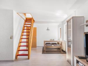 a wooden staircase in a room with a desk at Stylish apartment with terrace in Sonneberg in Sonneberg