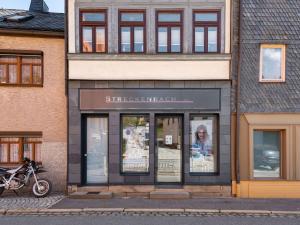 a store front with a motorcycle parked in front of it at Stylish apartment with terrace in Sonneberg in Sonneberg