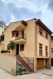 un gran edificio de ladrillo con una escalera delante de él en VUT Casa Orrios, en el centro de Alcañiz. en Alcañiz