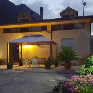 a house with a table and an umbrella at L'Acquario in Trecchina