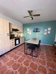 a kitchen with a table and a ceiling fan at Nuit En Brenne in Le Blanc