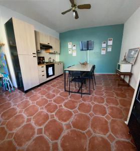 a kitchen with a table in the middle of a room at Chambre Centre Ville Le Blanc in Le Blanc +3 photos