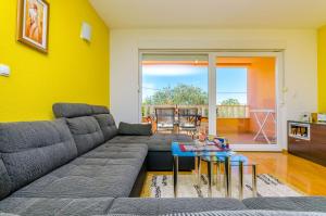 a living room with a couch and a table at Apartments Melita in Trogir