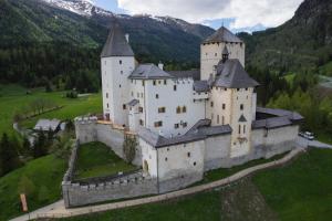 an aerial view of a castle in the mountains at Ferienwohnungen Schartner in Mauterndorf