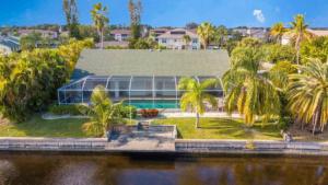 an aerial view of a house with palm trees at !NEW! Villa Rosa & Lucia in Cape Coral