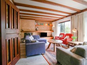 a living room with two couches and a table at Holiday home near the Efteling with garden in Nieuwkuijk