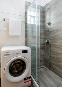 a washing machine in a bathroom with a shower at Stella Maris - Sivota Holiday Home in Sivota