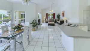 a kitchen and living room with white tile floors and a counter at !NEW! Villa Rosa & Lucia in Cape Coral