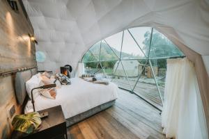 a bedroom with a bed in a tent at Cross Hill Glamping in Lake Hāwea
