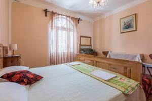 Postel nebo postele na pokoji v ubytování Villa Drago